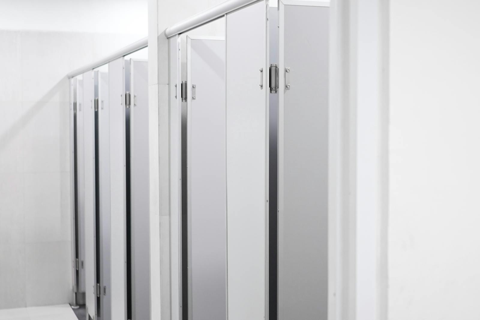 Clean and sleek public washroom with modern laminate partition cubicles.